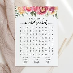 a baby shower word search card with flowers on it