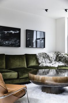 a living room with green couches and pictures on the wall above it that says instagram