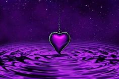 a purple heart floating on top of water