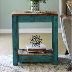 a small table with some books on it and a flower in a vase next to it