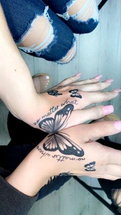 two women with tattoos on their hands and one has a butterfly tattoo on her arm