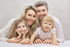 a happy family lying on the bed together