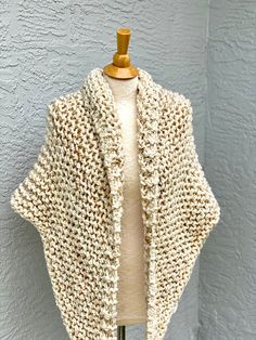 Hand knitted Outlander inspired shawl in cream blend. Wooden pin is NOT included. - triangle design, can be worn in many different ways - a small button can be attached to one of the tips, so you can secure it in the back for cross body style (if you desire a button, please include you request in a message to the seller at the check out) - super soft 90% acrylic, 10% sheep wool yarn - available in any color or yarn imaginable, please contact me for custom orders -made in smoke and pet free envir One Size Knit Shawl Knitting Pattern, Handmade Cream Shawl For Winter, Handmade Beige Shawl One Size, Cozy Cream Knitted Pattern, Handmade Cream Shawl One Size, Cozy Crochet Shawl One Size, Hand Knitted Beige Winter Shawl, Hand Knitted Beige Shawl For Winter, Cream Hand Knitted Shawl For Winter