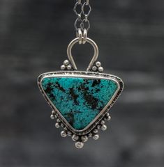 This necklace features a divine turquoise blue chrysocolla with some black speckled matrix. I have been on a huge chrysocolla kick recently and having a blast with all the different varieties I can find. This one is really gorgeous, I have added some granulation that is giving it some serious tribal boho flair. I feel like its just flashy enough like this, less would be boring and more would be too much but this is just right. The back is patterned with a complimentary pattern to the stone as we Turquoise Chrysocolla Necklace With Large Pendant, Healing Chrysocolla Pendant Turquoise Necklace, Turquoise Chrysocolla Necklace With Patina, Chrysocolla Turquoise Necklace Gift, Gift Turquoise Necklace With Large Chrysocolla Pendant, Unique Turquoise Chrysocolla Gemstone Necklace, Unique Turquoise Chrysocolla Necklace, Jewelry Pictures, Metal Art Jewelry