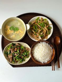 the meal is prepared and ready to be eaten on the tray with chopsticks