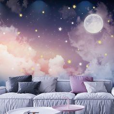 a living room filled with furniture and stars in the sky wallpapered on the walls