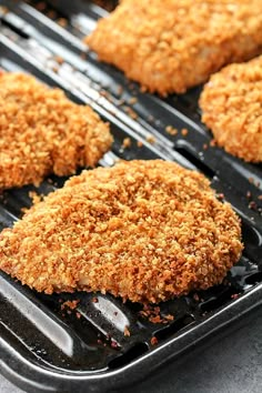 some chicken patties are cooking on a grill