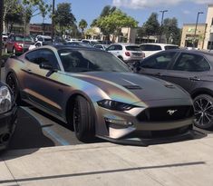 two cars parked next to each other in a parking lot