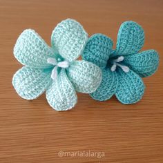 a crocheted flower on a wooden table