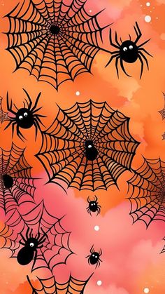 an orange background with black spider webs on it and pink clouds in the sky