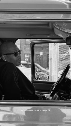 a man sitting in the driver's seat of a truck