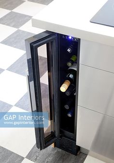 a wine cooler sitting on top of a checkered floor