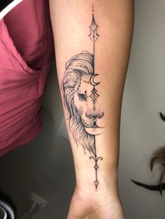 a woman's arm with a lion and moon tattoo on the left side of her leg