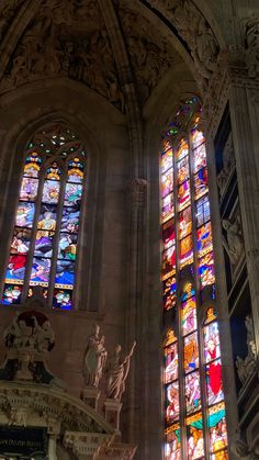 two large stained glass windows in a cathedral