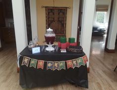 a black table topped with lots of items on top of a hard wood floored room