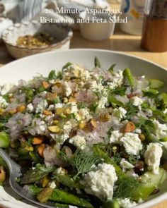 a white bowl filled with lots of food on top of a table