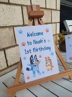 a wooden easel with a sign that says welcome to noah's 1st birthday