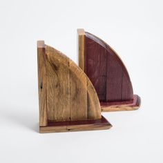 two pieces of wood sitting side by side on top of each other in front of a white background