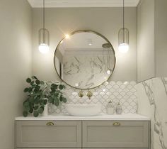 a bathroom with marble counter tops and white cabinets, round mirror above the sink on the wall