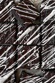 chocolate brownies covered in white icing and drizzled