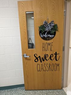 a welcome sign is on the front door of a home sweet classroom class room that's decorated with wreaths