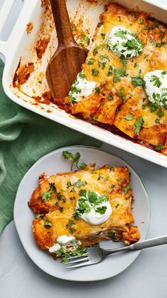 a casserole dish on a plate with a wooden spoon next to the casserole