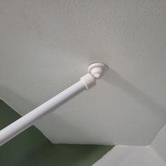 a white toothbrush is hanging from the ceiling