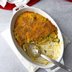 a casserole dish with broccoli and rice in it on a napkin