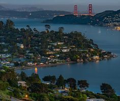 the golden gate bridge is lit up at night