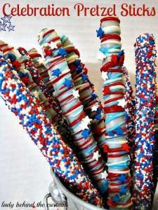 red, white and blue pretzel sticks are in a bucket with the words celebration pretzels