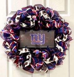 a new york giants wreath hanging on a door