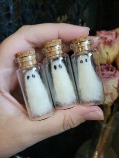 three small glass bottles filled with white stuff