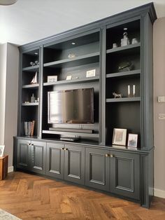 a large entertainment center with built - in bookshelves