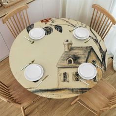 the table is set with white plates and place settings for four people to eat at