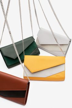 The Nia is the ultimate must have day-to-night accessory that transforms to a wallet, crossbody, or clutch carrying just the essentials. Handcrafted in Spain, the Nia features a contrasting leather or suede panel and detachable durable stainless steel chain. Chic Leather Wallet On Chain For Daily Use, Chic Everyday Wallet On Chain With Removable Pouch, Modern Wallet On Chain For Everyday Use, Modern Clutch Wallet On Chain For Everyday Use, Everyday Leather Wallet On Chain With Strap, Modern Clutch With Chain Strap For Daily Use, Modern Wallet On Chain With Removable Pouch, Chic Leather Wallet With Chain Strap, Chic Leather Wallets With Chain Strap