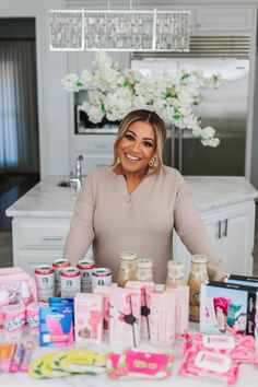 a woman standing in front of a table full of food and condiments on it