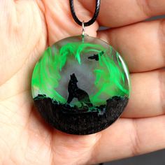 Our new model. Glowing wood resin pendant. The image of the wolf and the glow in the dark emphasize the beauty and uniqueness of this pendant. A perfect gift for the spirit of a totem animal. Materials: Bog Oak wood and resin, black cord, silver clasp. ► Your order will be packaged in a beautiful box, ideal for gifts, which is carefully packed in extra boxes for delivery. The pendant is made of wood with a jeweler resin and covered special natural oils in order to preserve the wood against exter Black Wolf Design Jewelry For Gift, Glow In The Dark Black Jewelry For Gift, Wood Resin Necklace, Totem Animal, Wood Resin Jewelry, Wolves Pendants, Wolf Necklace, Wood And Resin, Resin Ideas