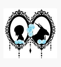 the silhouettes of two people in a heart shaped frame with blue flowers on them