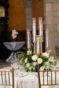 an elegant table setting with candles and flowers