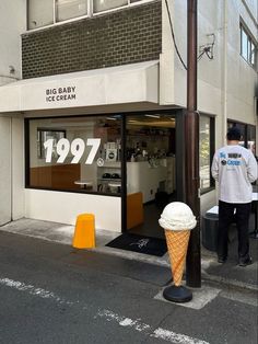 an ice cream cone sitting on the side of a street