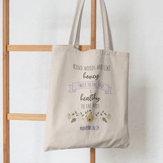 a tote bag hanging on a ladder with the words kind of words are like honey