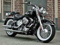 a black motorcycle parked in front of a brick building