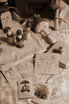 various crafting supplies are laid out on a table with sewing needles, cards and thread