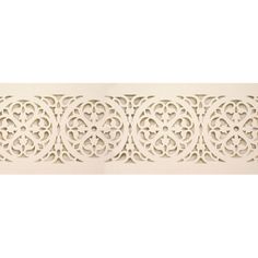 a decorative wall panel with an intricate design on the top and bottom, in white