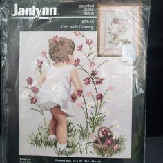 the cross stitch pattern is for a girl with flowers