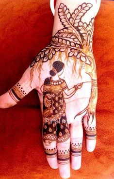 a person's hand painted with hennap and tattoos on the palm,