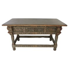 an old wooden table with two drawers on one end and carvings on the other side