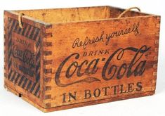 an old wooden crate with coca cola in it