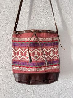 Hand woven in Guatemala Brown leather details & strap Suede lining inside One small pocket inside Woven Leather Bucket Bag For Market, Casual Brown Bucket Bag With Leather Trim, Casual Bucket Bag With Leather Trim, Woven Bucket Bag For Festival, Casual Festival Bucket Bag With Adjustable Strap, Woven Leather Shoulder Bag For Market, Vintage Woven Shoulder Bag For Everyday Use, Leather Woven Shoulder Bag For Market, Brown Bucket Bag With Adjustable Strap For Festival