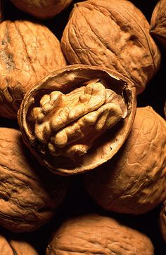 a bunch of walnuts that are sitting on top of each other in a pile